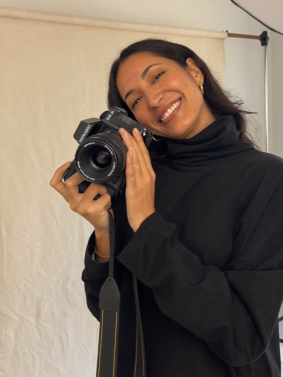 Anaya Rao, photographer, holding her camera in the studio